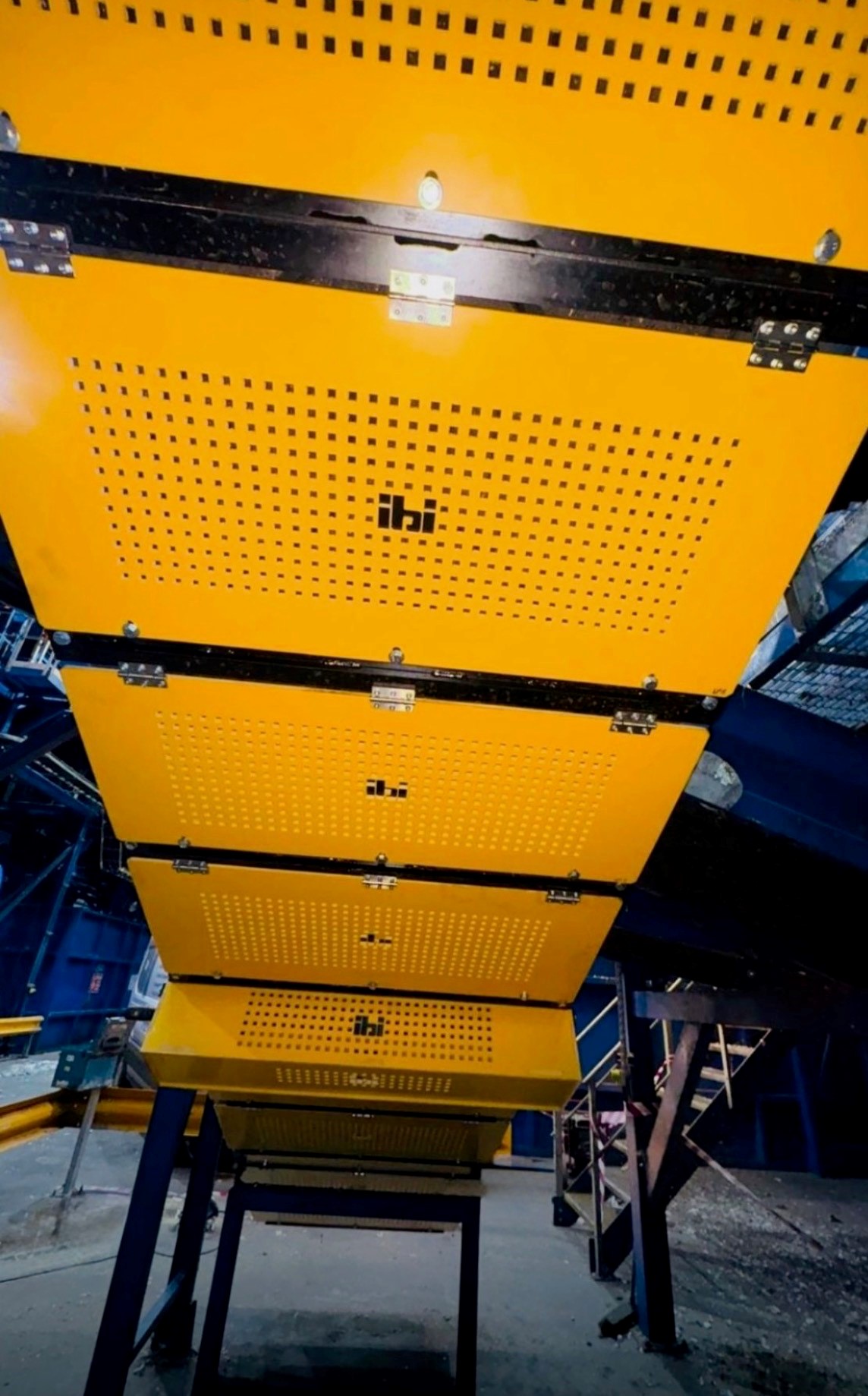 Bright yellow feeder hopper fabricated by IBI